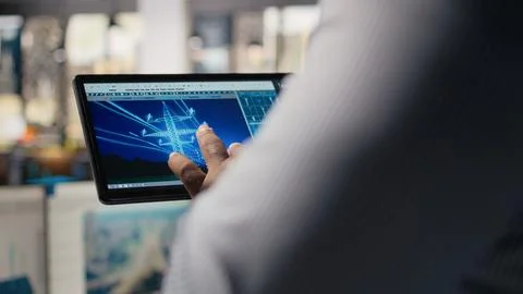 Close up of engineer using tablet to design power line towers in office Foto stock