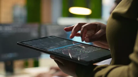 Close up of engineer using tablet to write code, developing machine learning API Stock Footage 313018225