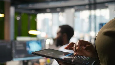 Close up of engineer using tablet to write code, developing machine learning API Stock Photos