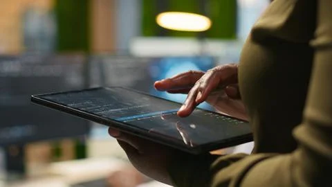Close up of engineer using tablet to write code, developing machine learning API Foto stock