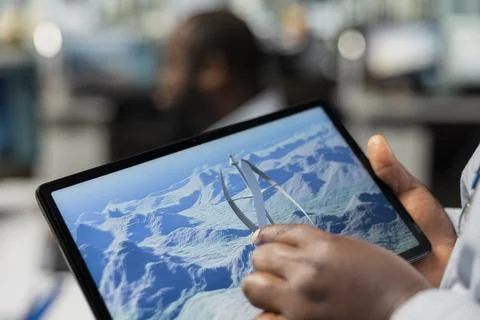 Close up of engineer using touchscreen device to analyze advanced wind turbine Stock Photos