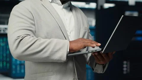 Close up of engineer walking in data center workplace, checking gear Stock Photos