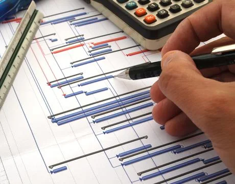 Close up of engineer working on time chart diagram, construction project gant Stock Photos