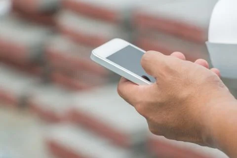 Close up of Engineering Businessman using mobile smartphone blurry background Stock Photos