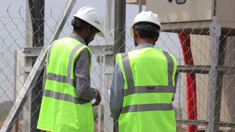 Close-up of engineering professionals reviewing site data and blueprints at an Stockbeeldmateriaal 336395261