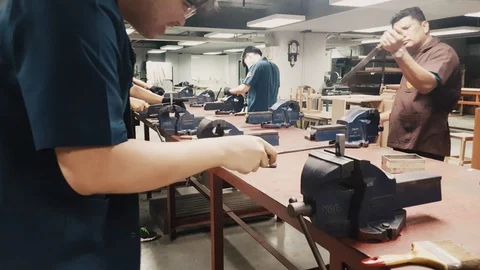 Close up of Engineering student filing metal in workshop class Stock Footage 102571621