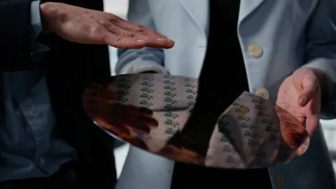 Close up of engineers examining silicon wafer, trialing advanced materials Stock Footage 335882640