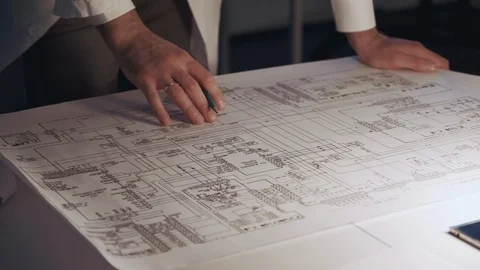 Close up of engineer's hands making notes on control electronics scheme Stock-Footage 112871073