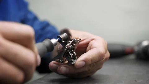 Close-up of an engineer's hands polishing a metal part Stock Footage 259613293