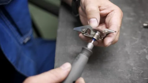 Close-up of an engineer's hands polishing a metal part Stock Footage 259613404