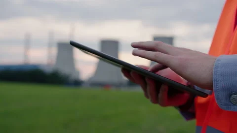 Close-up of an engineer's hands with a tablet.Checking the safety of power grids Stock Footage 234589417