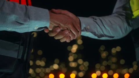 Close up engineers shaking hands together at petroleum oil refinery. Stock Footage 270460768