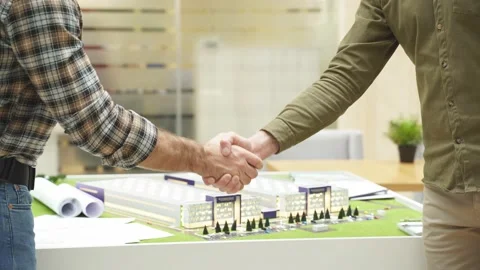 Close-up of engineers shaking hands while working for teamwork in office. Stock Footage 145356955