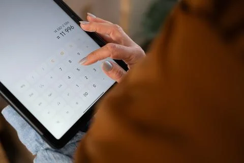Close up of entrepreneur hands working with screen calculator on digital tabl Stock Photos