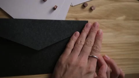 Close-up of the envelope and the person's hand. Slow motion. Run your hand over  Stock Footage 147546158