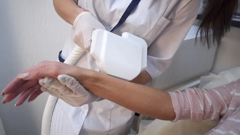 Close up of Epilation Procedure with Laser on Woman's Arm Stock Footage 121618629