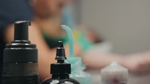 Close-up equipment at desk. Master makes tattoo to woman client in studio. Stock Footage 219549142