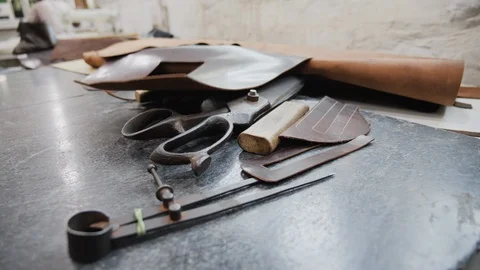 Close up of equipment on factory table for working with leather, Kalkata, India Stock Footage 145038271