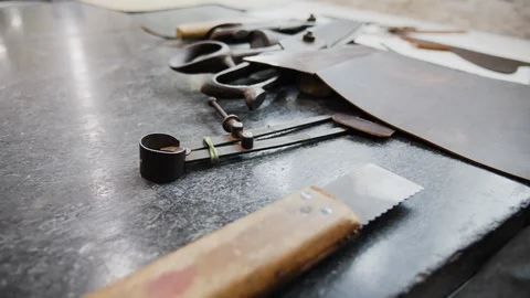 Close up of equipment on factory table for working with leather, Kalkata, India Stock Footage 145038823