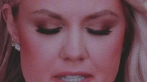 A close-up of Erika Kirk on the stadium video wall Stock Footage 345298601