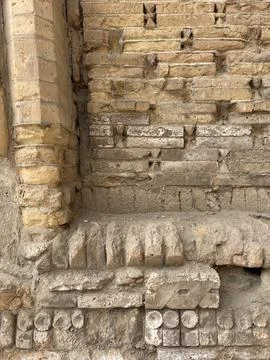 Close-up of eroded brick facade with decorative, geometric pattern Stock Photos