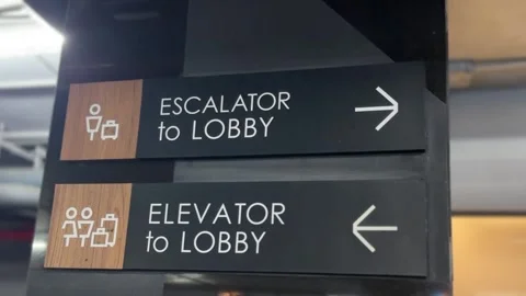 Close-up of “Escalator to Lobby” and “Elevator to Lobby” sign Stock Footage 312099926