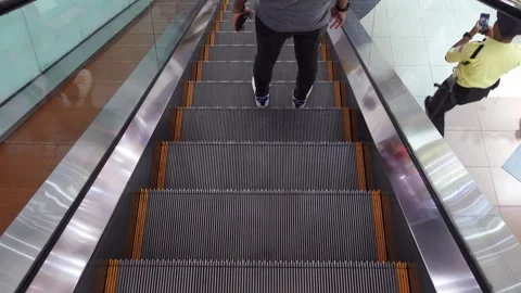 Close up of an escalator moving down in a mall Stock Footage 275311846