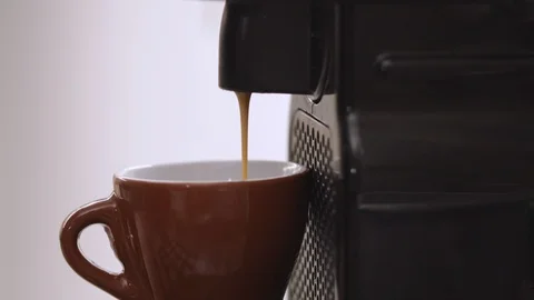 Close Up Of Espresso coffee falls into a brown cup. Macro shot. Home machine. Stock Footage 122299035