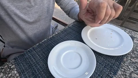 A Close-Up of an Espresso Cup in Hand with an Empty Plate, Capturing the Final Stock Footage 331084134