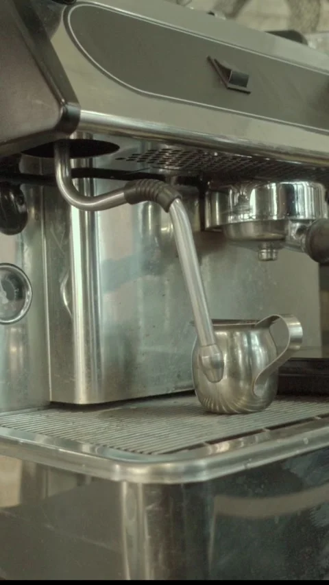Close Up of Espresso Machine Steam Wand and Metal Pitcher in Coffee Shop Stock Footage 337921852