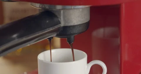Close-up of espresso machine while coffee goes through Stock Footage 99750390