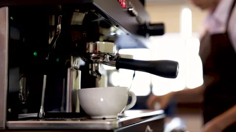 Close-up espresso pouring from coffee machine, young barista training girl .. Stock-Footage 245049248