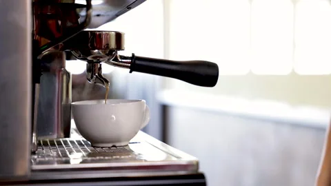 Close-up espresso pouring from coffee machine, young barista training girl .. Stock Footage 245049386