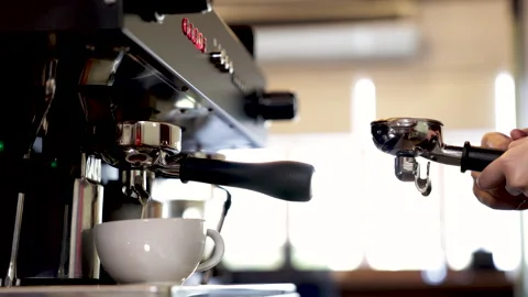 Close-up espresso pouring from coffee machine, young barista training girl .. Stock Footage 245049562