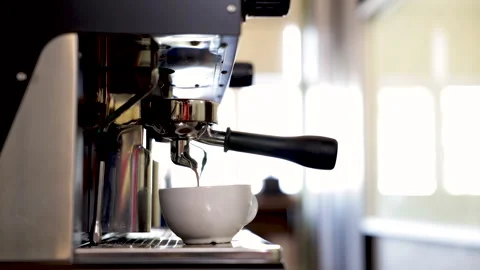 Close-up espresso pouring from coffee machine, young barista training girl .. Stock Footage 245049588