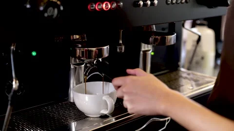 Close-up espresso pouring from coffee machine, young barista training girl .. Stock Footage 245051262
