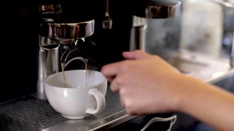 Close-up espresso pouring from coffee machine, young barista training girl .. Stock Footage 245051295