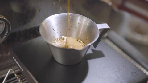 Close Up of Espresso Pouring From Coffee Machine Into Metal Cup Stock Footage 342016056