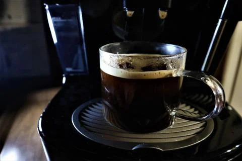 Close-up of espresso pouring from coffee machine. Stock Photos