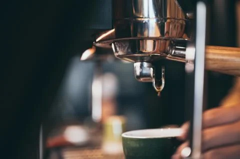 Close-up of espresso pouring from coffee machine. Professional coffee brewing Stock Photos