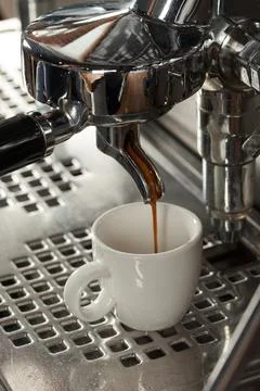 Close-up of espresso preparing in coffee machine, selective focus Stock Photos