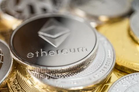 Close-up of ether physical coin on stack of many other cryptocurrencies Stock Photos