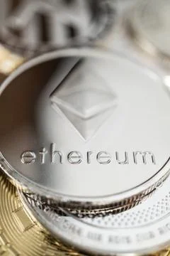 Close-up of ether physical coin on stack of many other cryptocurrencies Stock Photos