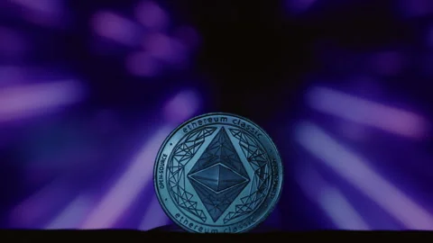 Close-up: Ethereum physical coin on an abstract background. Golden ETH logo with Stock Footage 332619502