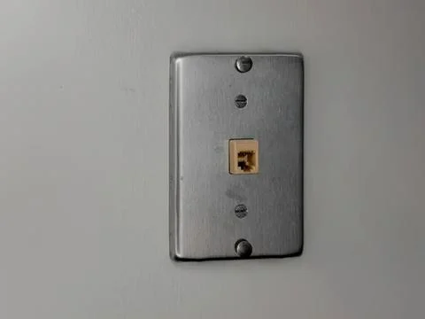 Close-up of an ethernet wall socket on a plain wall Stock Photos