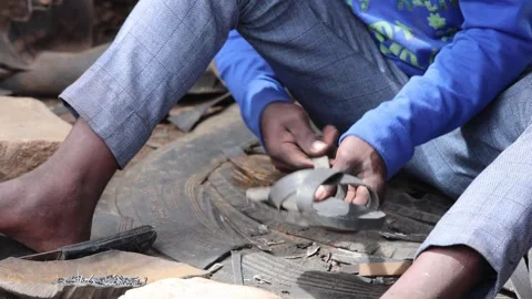 Close up of Ethiopian worker making shoes from old tires. Stock Footage 307429190