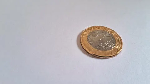 Close-up of a Euro coin on a plain surface. Financial concept and currency Stock Photos