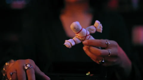 Close-up of evil witch hands holding voodoo doll, occult ritual, black magic Stock Footage 179967187