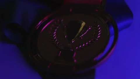 Close Examination Of Intricately Designed Medal With Metallic Finish And Velvet Stock Footage 335993553
