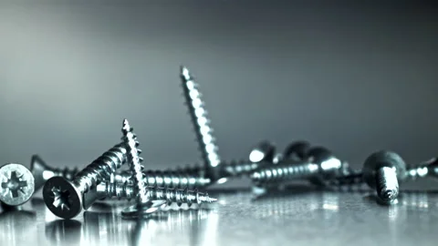 Close examination of threaded metal screws in studio setting Filmed on a high Stock Footage 335412045